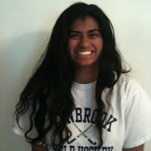 Aditi Pradhan Hometown: San Jose, CA_2011-2012 Classe A segunda classe de Conselheiros Adolescentes (foto de ângulo estreito, mas não uma imagem clara) uma adolescente vestindo a sua camisa branca de hóquei com a sua cara sorridente virada para a câmara, e o fundo é branco