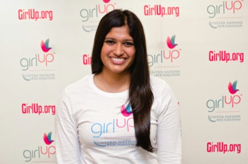 Archana Somasegar_2012-2013 Class Teen Advisors (close angle headshot, a picture little blurry ) a teen girl wearing her girl up white shirt with her smiley face facing the camera, and background is girlup.org board