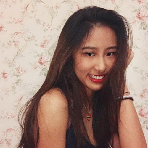 Aria Yang: Consejeras adolescentes 2019-2020, (retrato, mirando hacia abajo) sonriendo a la cámara y con su mano izquierda sosteniendo la cabeza.