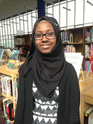 Faatimah Solomon 2016-2017 Teen Advisors (close half body shot) with library background and she is wearing her black Hijab on