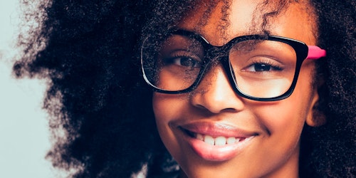 (close cutoff shot) a girl with big glasses on and a big smile