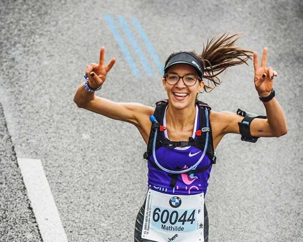 (upper angle) girl name Mathilde running and pose victory sign with her hand