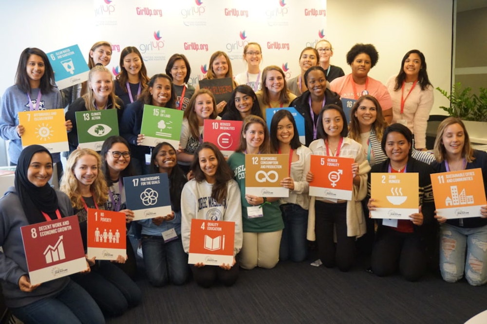 a group of Girl Up girls holding SDGs sign at the girl up event