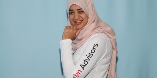 Leena teen advisor (girl up shirt)pose for the picture with her Hijab on (blue background)