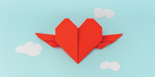 a paper folded heart with wings