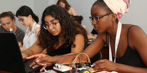 two Girl Up girls working on a STEM project with their computer (WiSci Summit)