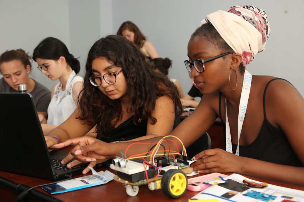 two Girl Up girls working on a STEM project with their computer (WiSci Summit)
